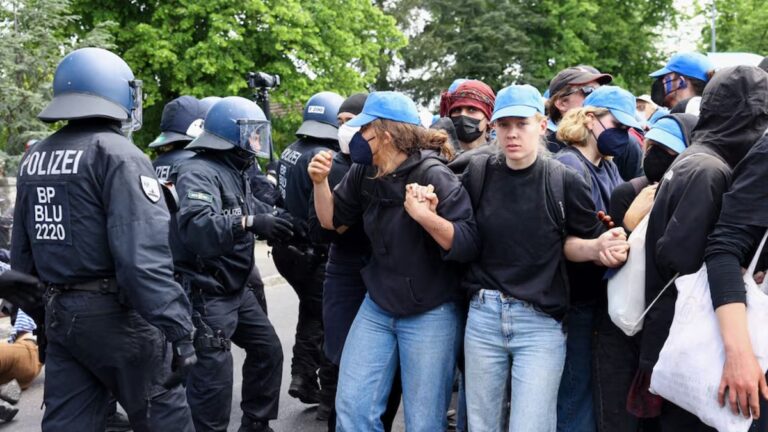 Activists-form-a-human-chain-next-to-police-forces-during-a-protest-against-the-expansion-of-the-Tesla-Gigafactory